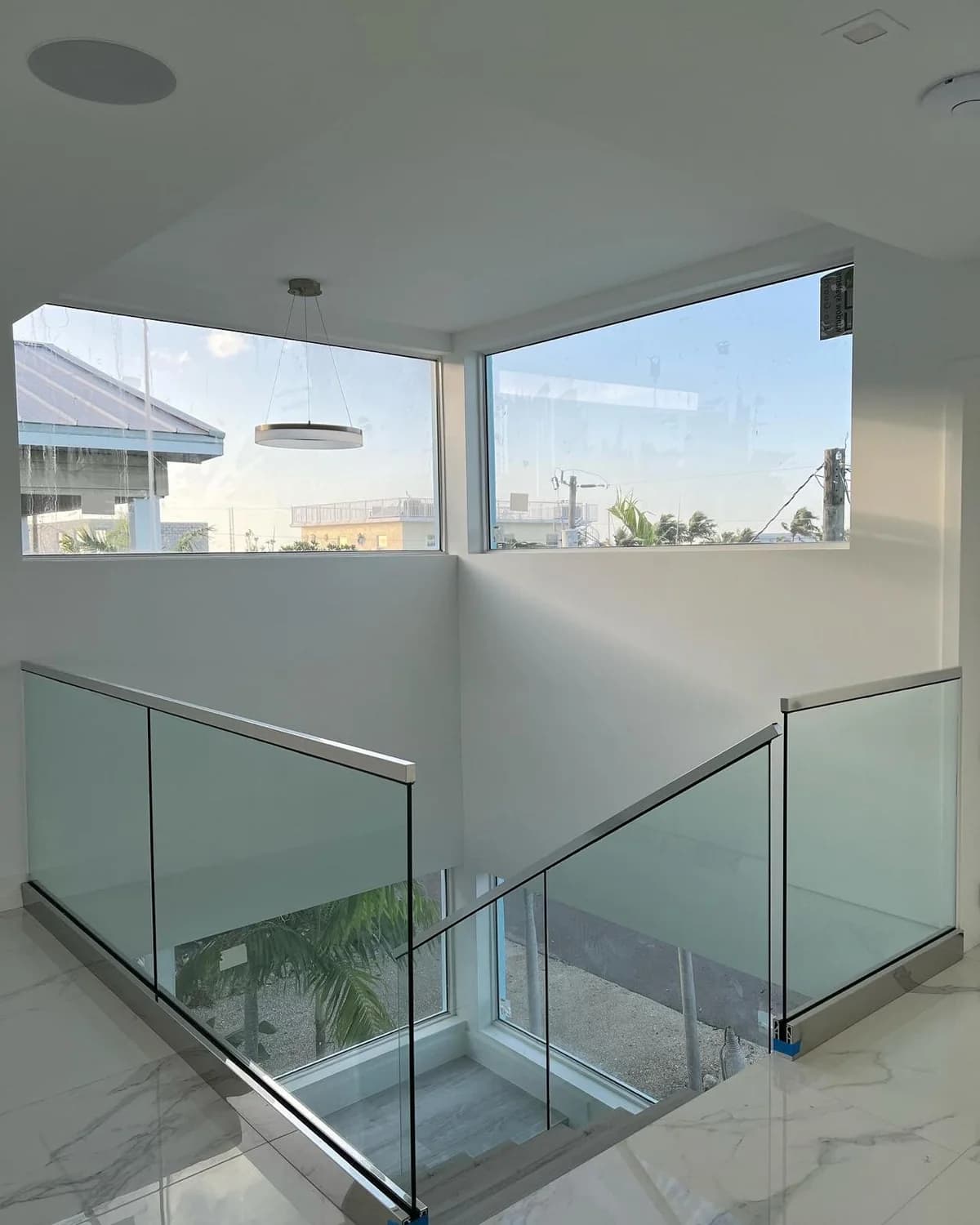 Frameless glass panels with stainless hardware installed by Eastern Glass in a South Florida home